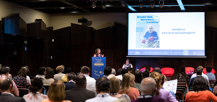 Steering group member Clare Cook presents the magazine at the 11th IPCRG World Conference in Málaga, Spain